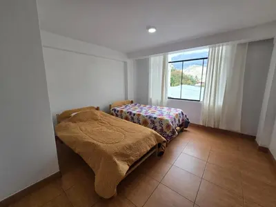 a bedroom with two beds and a window at 402G Modern equipped apartment in Abancay
