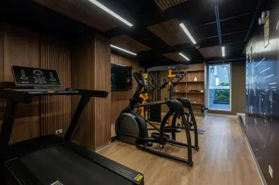 a gym with a treadmill and a bike in a room at The Sight by Geko in Lima