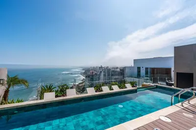 a swimming pool on top of a building with the ocean at The Sight by Geko in Lima