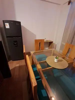 a dining room with a glass table with a cup on it at BellaVista Hospedaje Casa completa, cocina y terraza in Oxapampa