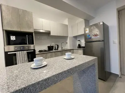 a kitchen with a counter with two cups on it at Departamento con baño y cocina equipada in Lima