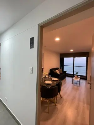 a living room with a table and a couch at Departamento con baño y cocina equipada in Lima