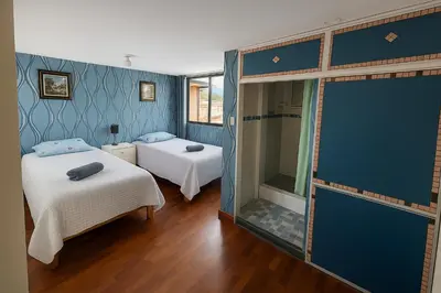 a small room with two beds and a mirror at Casa Victoria