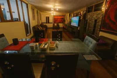 a living room with a dining table and a television at Casa Victoria