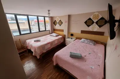 a room with two beds and a window at Casa Victoria