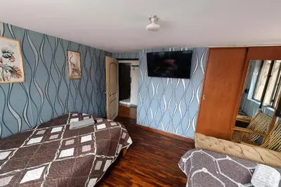 a bedroom with a bed and a tv on the wall at Casa Victoria