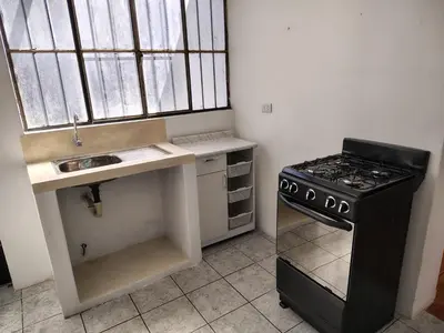 a small kitchen with a stove and a sink at Family Days in Ica