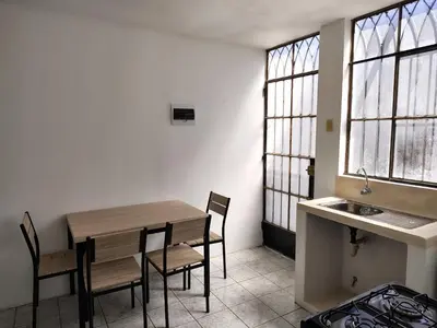 a kitchen with a table and chairs and a sink at Family Days in Ica
