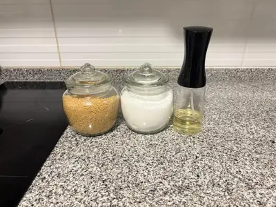 two jars of oil and a vase on a counter at Acogedor Loft con ubicación céntrica en Lima in San Antonio
