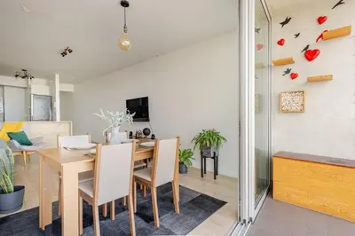 a dining room and living room with a table and chairs at Miraflores - departamento con 3 dormitorios in Lima