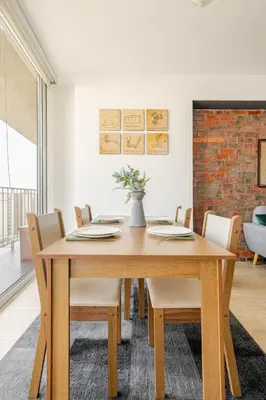 a dining room with a wooden table and chairs at Miraflores - departamento con 3 dormitorios in Lima