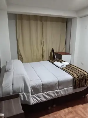 a bedroom with a large bed with two towels on it at Refugio Sagrado Boutique in Cusco