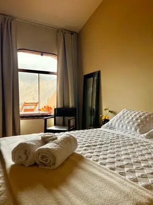 a bedroom with a bed with towels on it at Rosa Estela in Cieneguilla