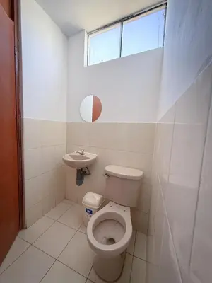 a bathroom with a toilet and a sink at Hospedaje Arco Real in Ica