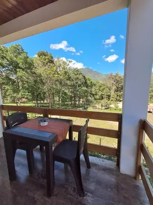 a table and chairs on a porch with a view at BellaVista 2 habitaciones con balcón in Oxapampa