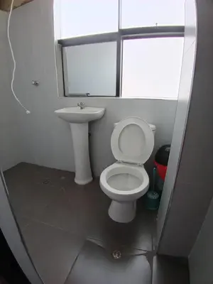 a bathroom with a white toilet and a sink at Chepe de mi Corazon in Abancay