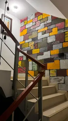 a stone wall with a mural on the side of a staircase at Hotel D'Gloria Churin in Churín
