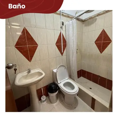 a bathroom with a toilet and a sink at Departamentos Sumaq Plaza - Bellido in Ayacucho