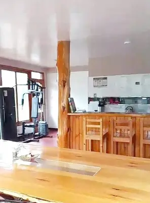 a kitchen with a wooden counter top in a room at La casa de Cuni in Oxapampa