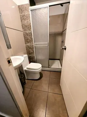 a bathroom with a toilet and a sink and a shower at barranco apartament R&M in Lima