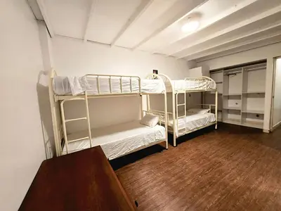 two bunk beds in a room with a wooden floor at barranco apartament R&M in Lima