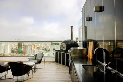 a kitchen with a view of a city at View & Pool Barranco loft G15 in Lima