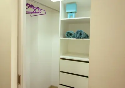 a walk in closet with white shelves and towels at View & Pool Barranco loft G15 in Lima