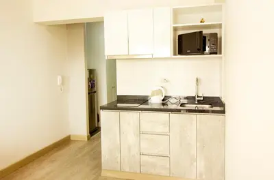 a kitchen with white cabinets and a sink at View & Pool Barranco loft G15 in Lima