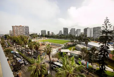 a city street with a lot of traffic and buildings at View & Pool Barranco loft G15 in Lima