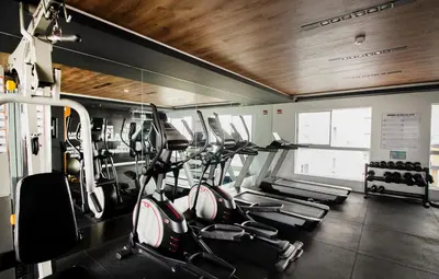 a gym with several treadmills and cardio machines at View & Pool Barranco loft G15 in Lima