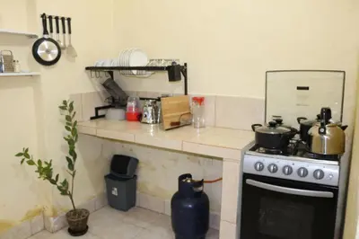 a kitchen with a stove and a counter top at Apartamento Privado en San Pedro Cusco in Cusco