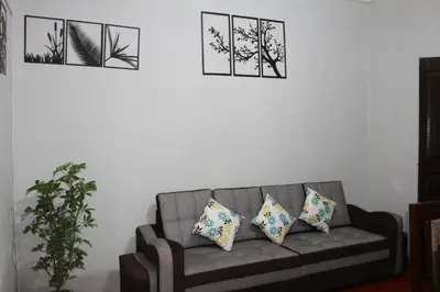 a living room with a gray couch with three pillows at Apartamento Privado en San Pedro Cusco in Cusco