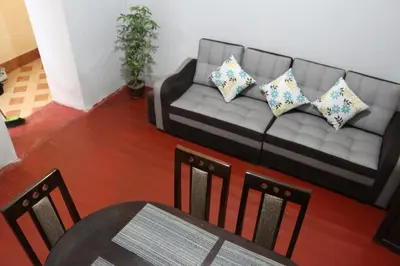 a living room with a couch and a table and chairs at Apartamento Privado en San Pedro Cusco in Cusco