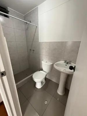 a bathroom with a toilet and a sink at Departamento San Sebastian in Lima