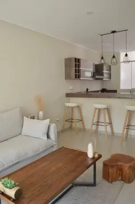 a living room with a couch and a table at CASA DUNE Acogedora casa a 7 minutos Huacachina in Ica