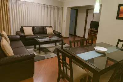 a living room with a couch and a table at Bella vista al malecón Lima - Miraflores in Lima
