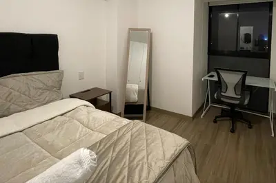 a bedroom with a bed and a desk and a chair at Brand new apartment in Miraflores in Lima
