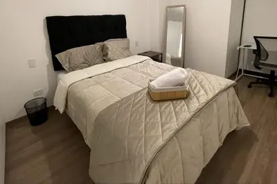 a bedroom with a large bed with a tray on it at Brand new apartment in Miraflores in Lima