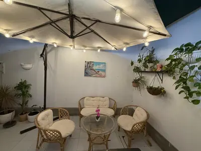 a room with chairs and a glass table and a group at Ethan's House - Como en Casa