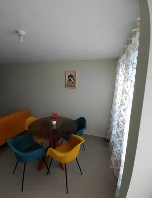 a dining room with a table and chairs at Depa Amoblado en Villa María, Excelente ubicación, WiFi, y Parking in Villa María del Trunfo