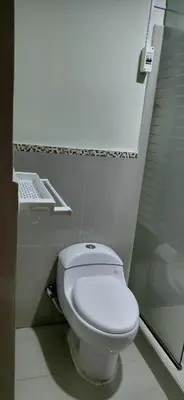a bathroom with a toilet and a glass shower at Depa Amoblado en Villa María, Excelente ubicación, WiFi, y Parking in Villa María del Trunfo