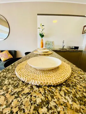 a table with a plate on top of a counter at San Miguel Apartment Vista Mar in Lima