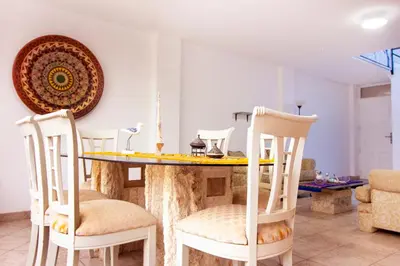 a living room with a table and chairs at Casa Las Brisas de Villa frente al mar in Lima