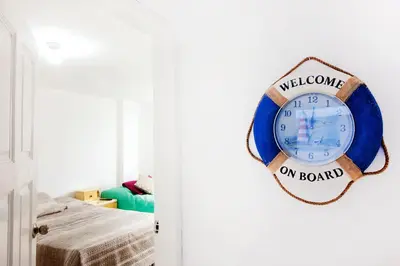 a clock hanging on a wall in a room at Casa Las Brisas de Villa frente al mar in Lima