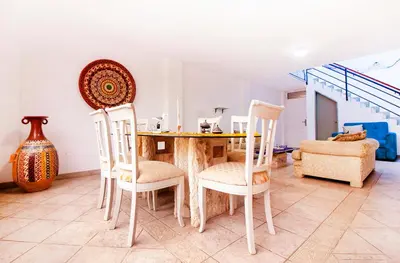 a dining room with a table and chairs at Casa Las Brisas de Villa frente al mar in Lima