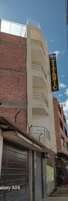 a building with a sign on the side of it at Hospedaje TITANIC in Huancayo