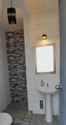 a bathroom with a sink and a window at Casa con piscina, terraza y parrilla en Ica in Ica