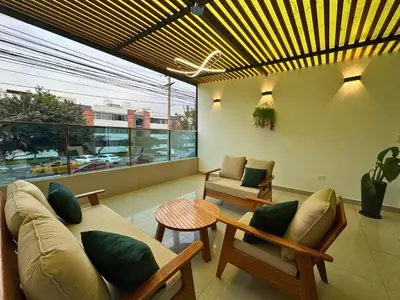 a living room with a couch and chairs and a table at City Tower Hotel in Lima