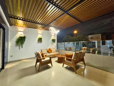 a living room with two chairs and a couch at City Tower Hotel in Lima