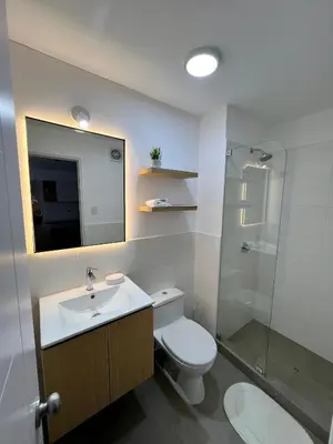a bathroom with a toilet and a sink and a shower at Moderno Departamento con Terraza, cerca a la Playa in Lima